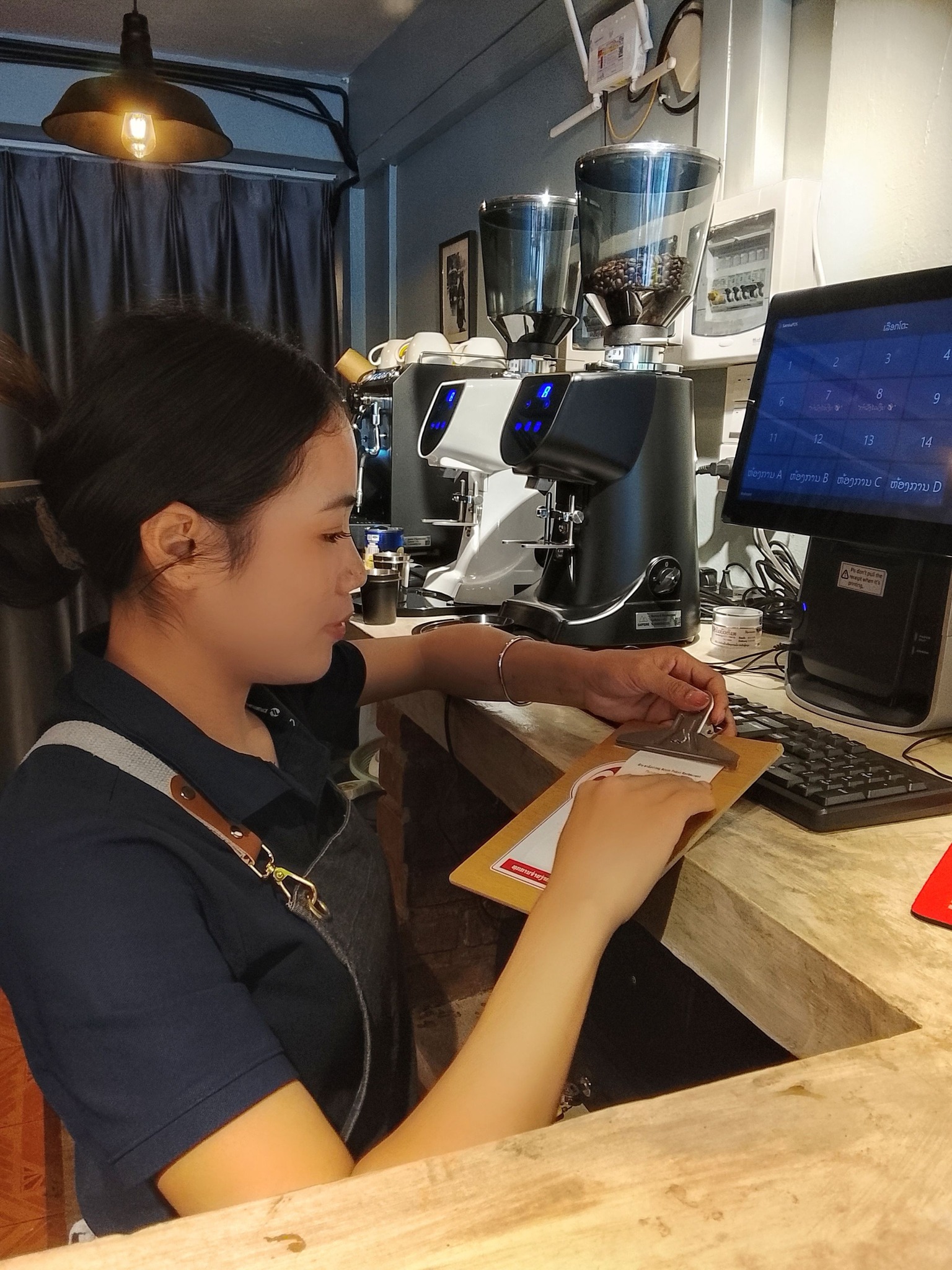 Arom Pakse Restaurant cashier at work